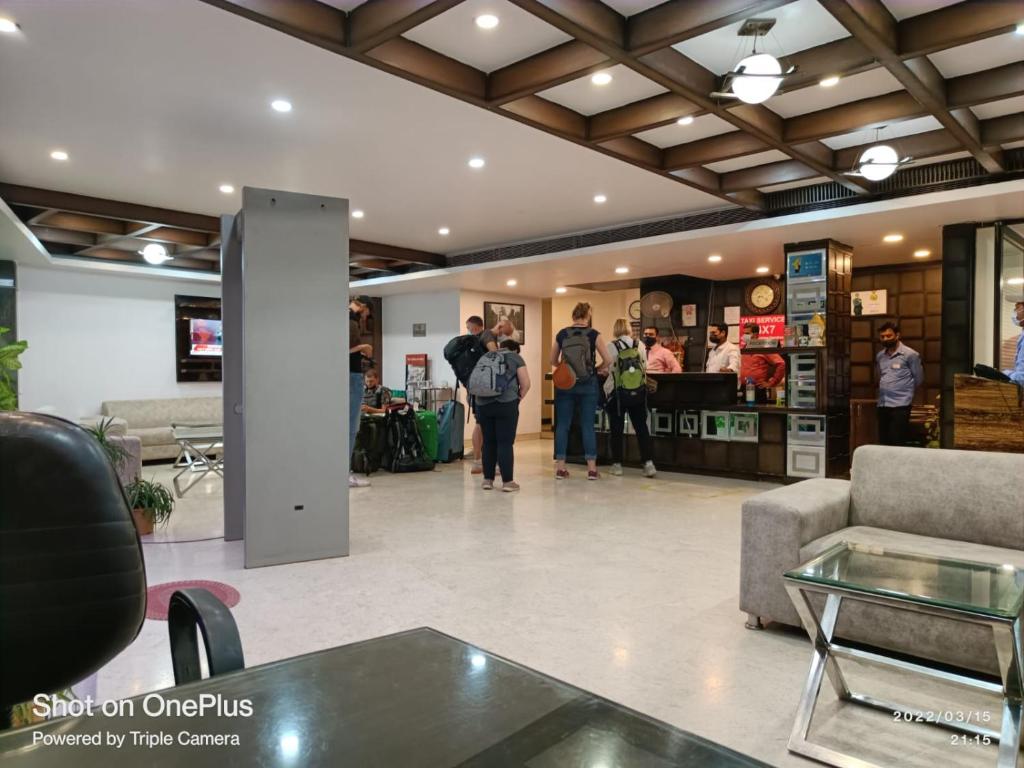 a group of people standing in a store lobby at Hotel Decent Aerocity - Mahipalpur, Delhi Airport in New Delhi
