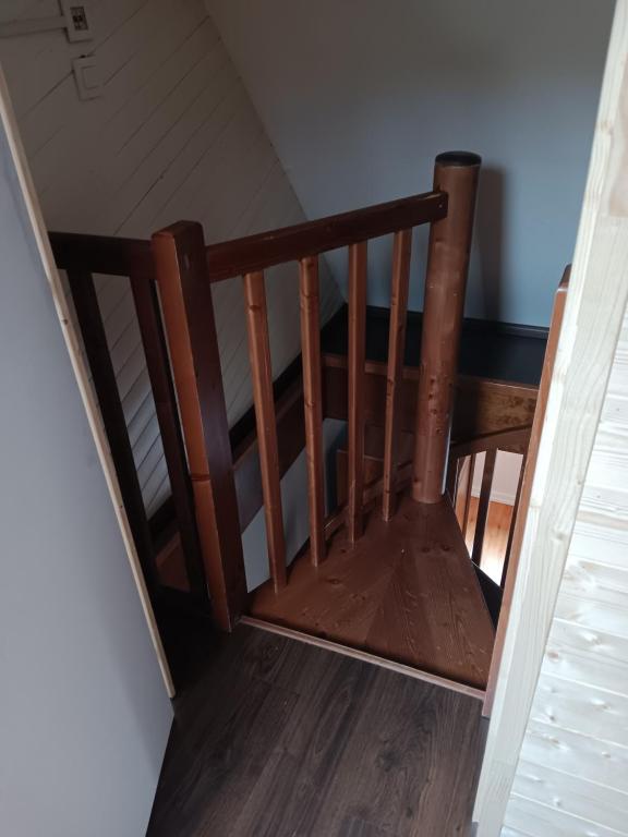 a wooden stairwell with a wooden chair in a room at Superbe gite au centre de Kaysersberg avec 3 chambres in Kaysersberg