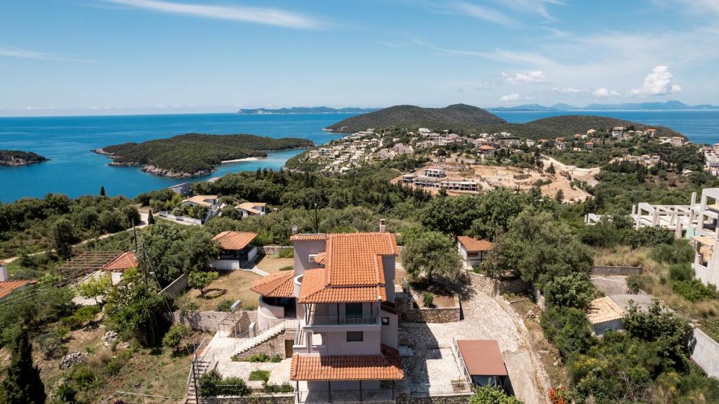 an aerial view of a house on a hill next to the water at ArtView Villa in Syvota