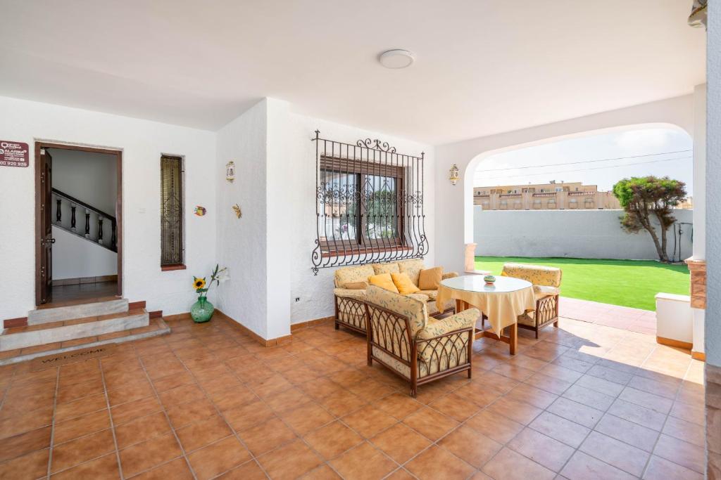 a living room with a table and chairs at Casa en Cabo de Gata con barbacoa y Jardín, cerca de la playa in El Cabo de Gata