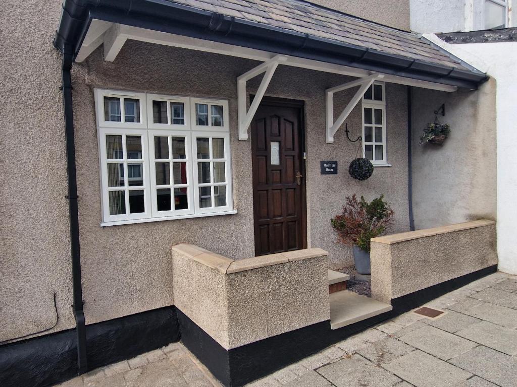 a house with an awning on the side of it at Two bedroom character cottage in Rhuddlan