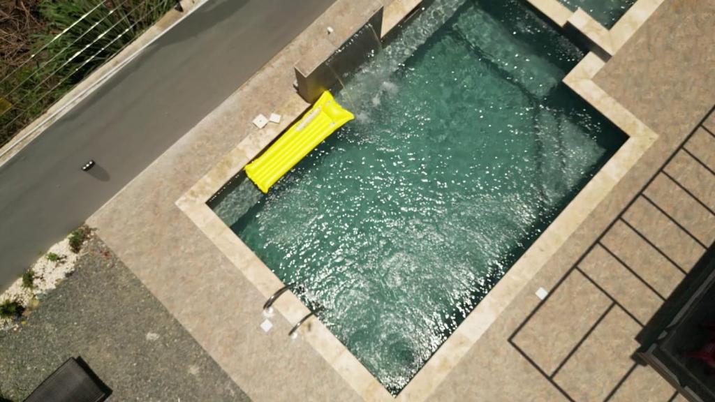 a pool of water with a yellow object in it at Villa Ybelis Paradise in Concepción de La Vega