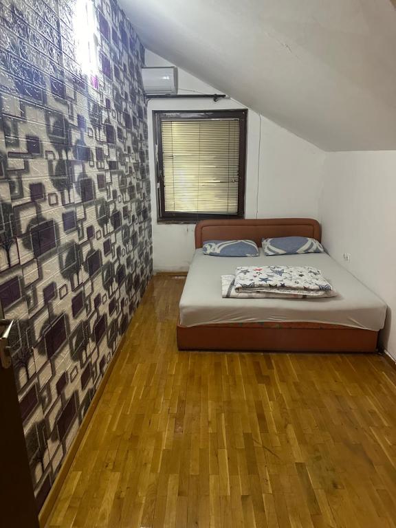 a bedroom with a bed in a small room at House in Center in Skopje
