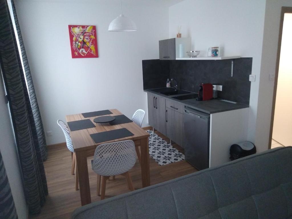 a small kitchen with a table and a sink at Appartement F2 neuf in Jarville-la-Malgrange