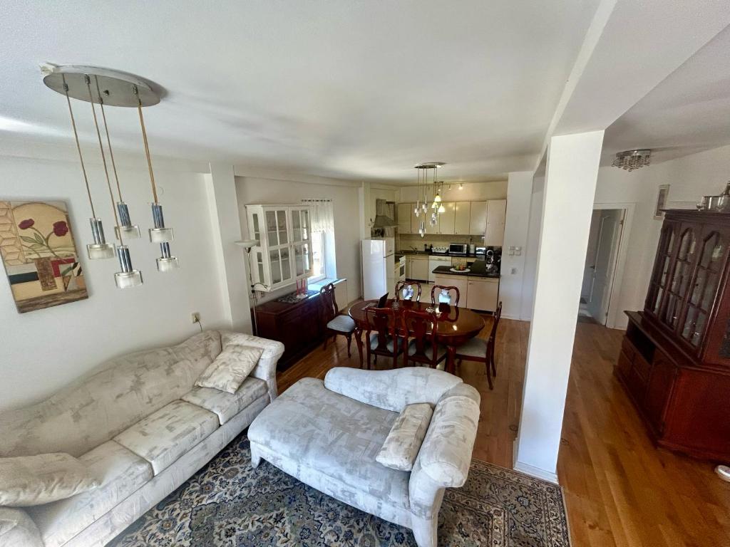 a living room with two couches and a dining room at Vila Nada Apartment in Vrnjacka Banja in Vrnjačka Banja
