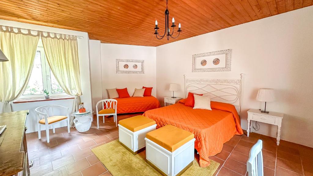 a bedroom with two beds with orange sheets at B&B La Terazza Sul Cielo di Maratea in Maratea