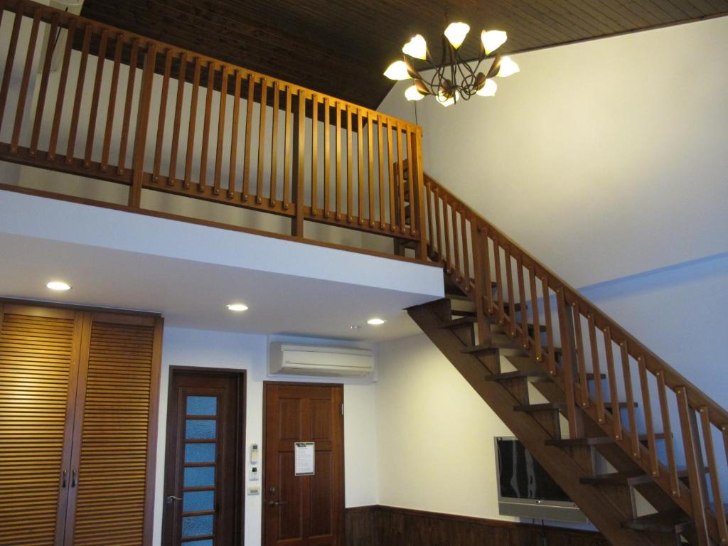 a staircase in a house with a ceiling at LivingGreen B&amp;B in Luodong
