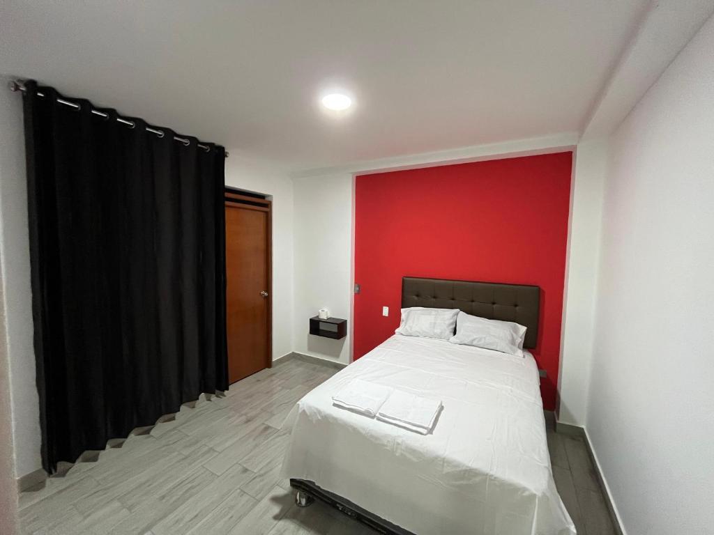 Un pat sau paturi într-o cameră la Hospedaje Limatambo