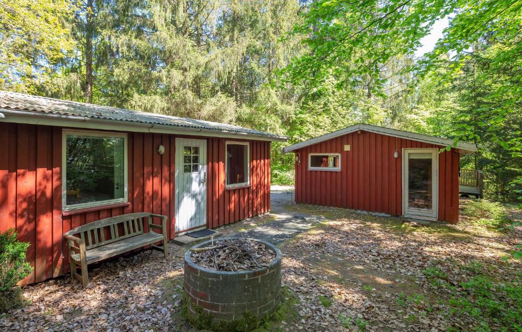 a red cabin with a bench in front of it at Stunning Home In Silkeborg With Wifi in Silkeborg