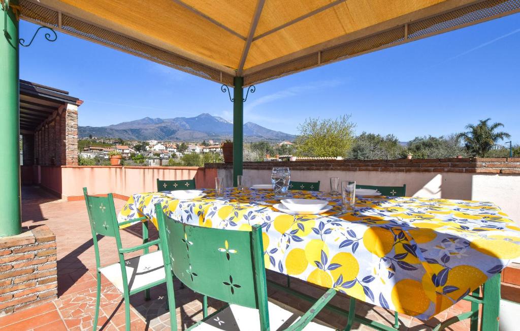 a table with a yellow and blue tablecloth on a patio at Fiori in Santa Venerina