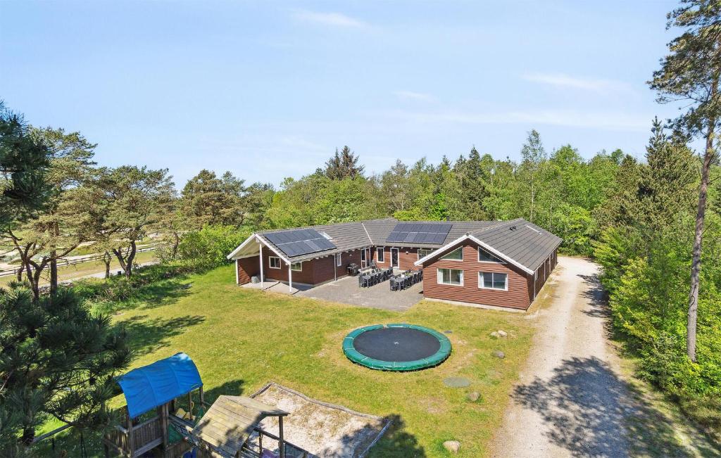 an aerial view of a house with a playground at Holiday Home Tværvænget Blåvand in Ho