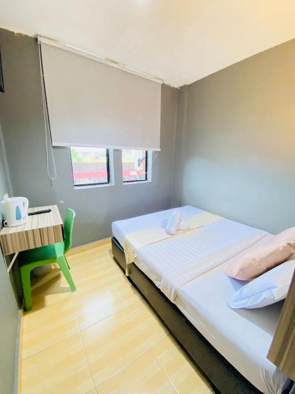 Postel nebo postele na pokoji v ubytování DJ Citi Inn Premier