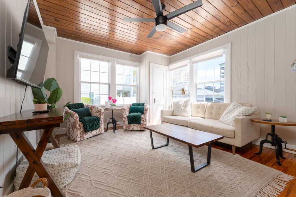 a living room with a couch and a table at Be A Nomad - Beach Bliss - Close to beach in Jacksonville Beach
