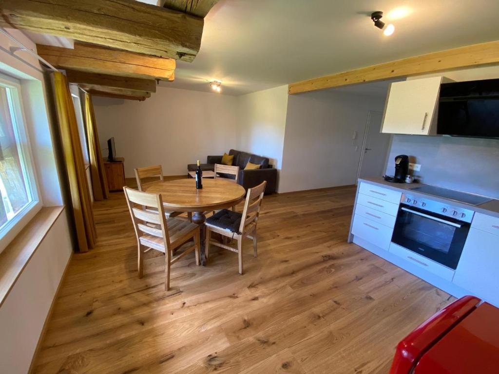 a kitchen and dining room with a table and chairs at Hofgut Breitenbach in Markdorf