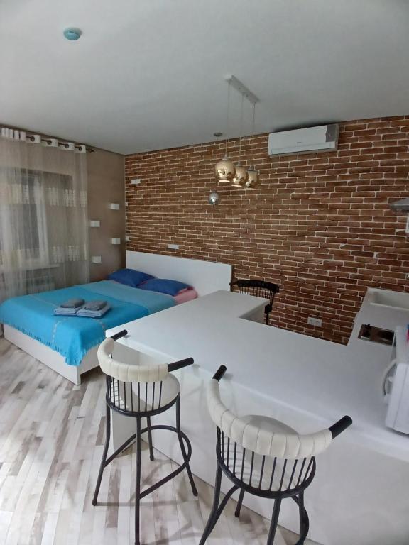 1 dormitorio con 1 cama, mesa y sillas en ЖК "Радужный берег" аэропорт 1 комнатная en Turksib