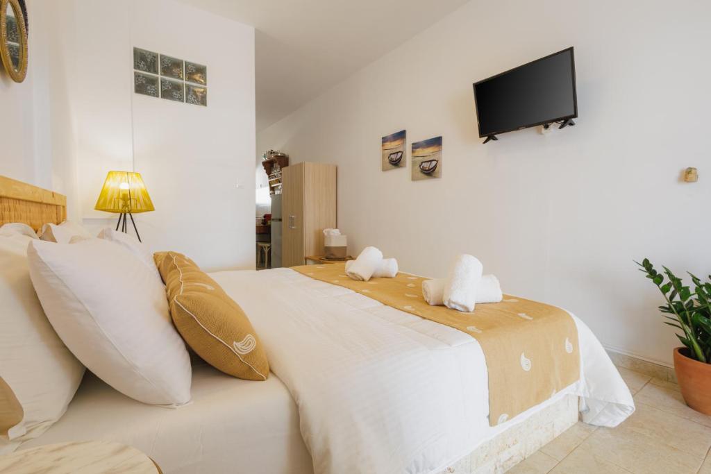 a bedroom with a bed with two stuffed animals on it at Studios Eliza in Livadi