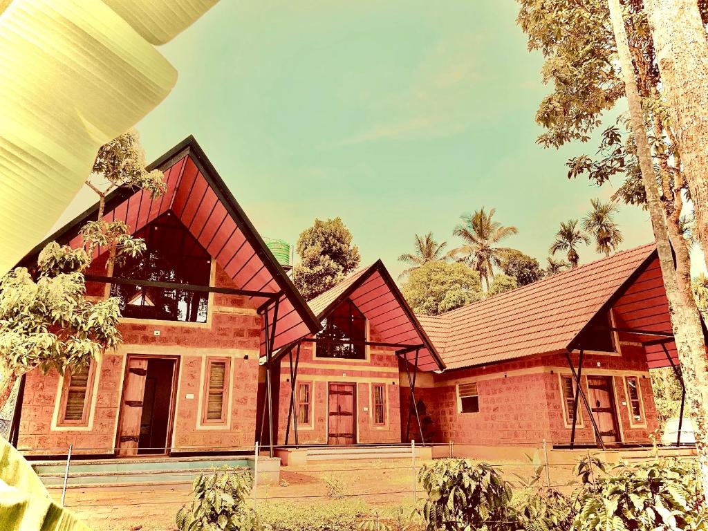 a house with a red roof at Senthamarai homestay in Sultan Bathery
