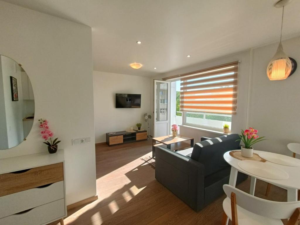 a living room with a couch and a table at Sea Sand apartment in Liepāja