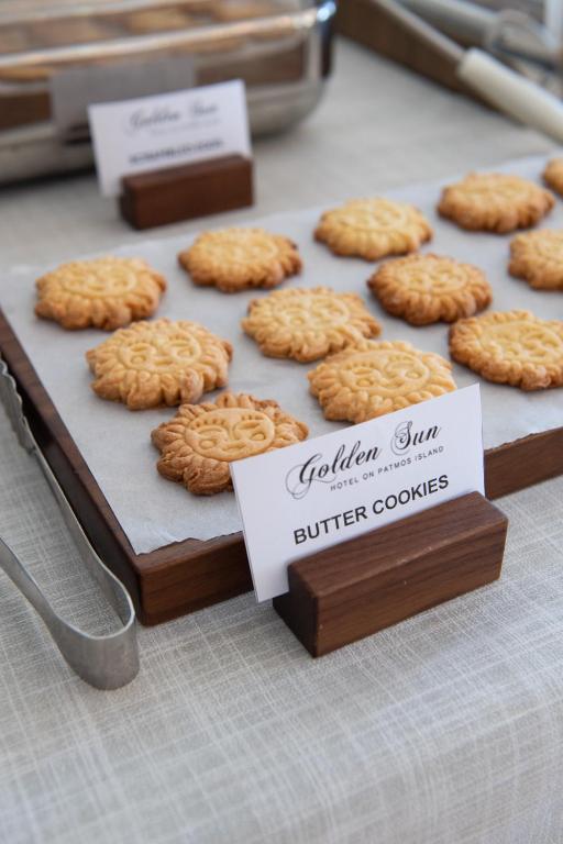 a bunch of cookies on a table with a sign at Golden Sun Hotel Patmos in Patmos