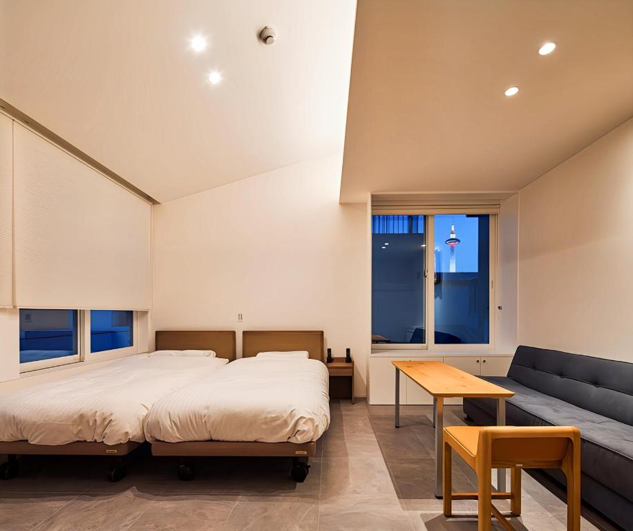 a bedroom with a bed and a couch at ホテルトーイン京都 in Kyoto