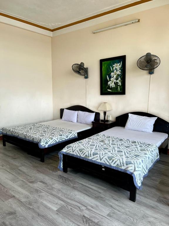 Postel nebo postele na pokoji v ubytování Xuân Hồng Guest House