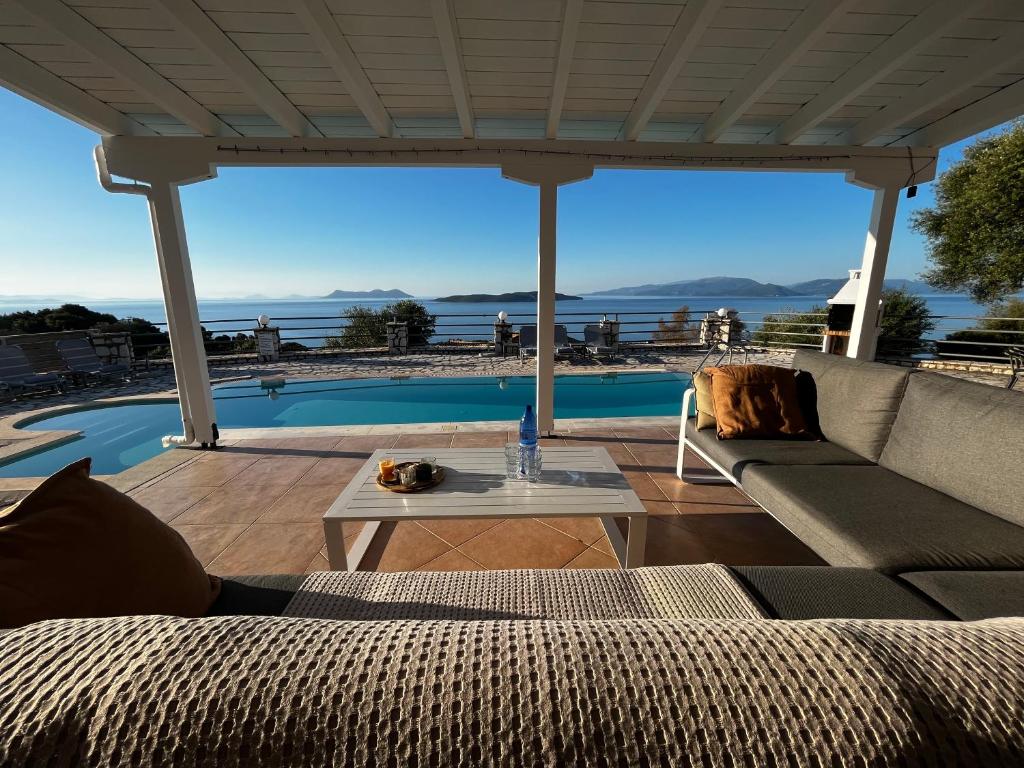 a living room with a couch and a table at Villa Olivia Greece with private pool & seaview in Sivota Lefkada in Sivota