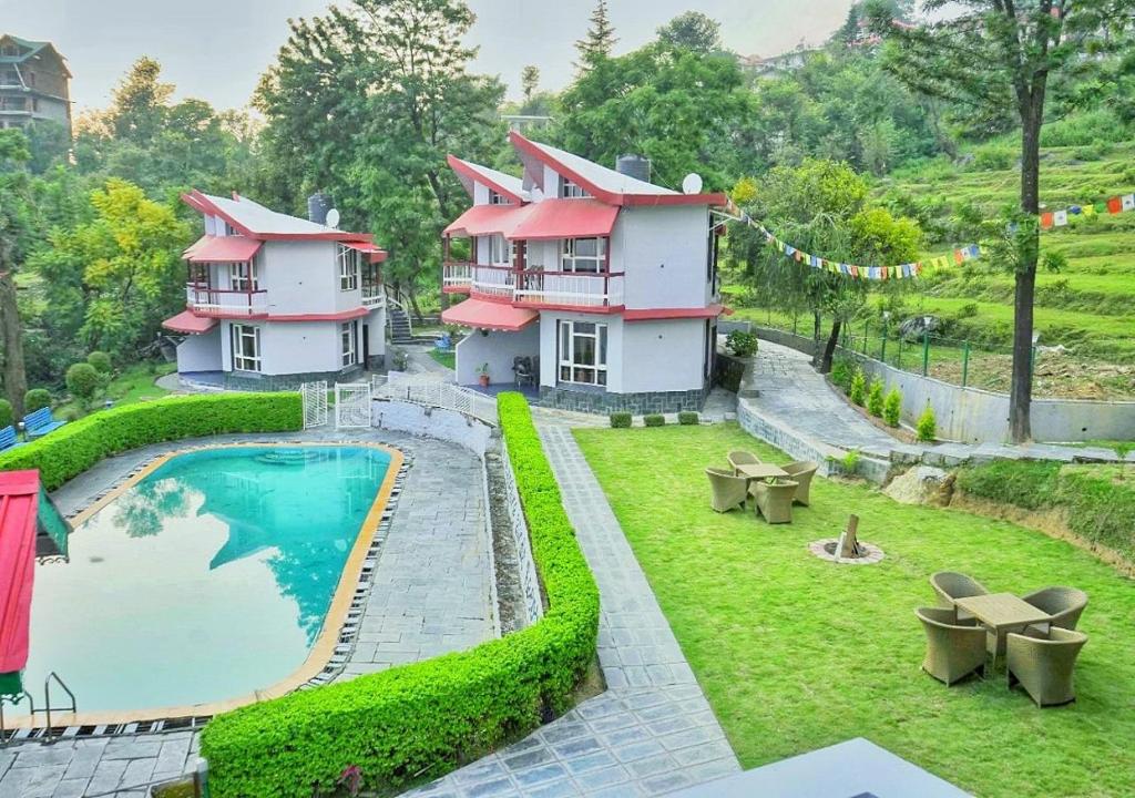 an aerial view of a house with a swimming pool at Whispering Winds Resort in Dharamshala