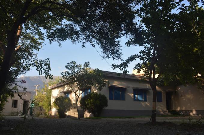a white house with trees in front of it at Hanaly Wood Resort & Cafe in Gilgit