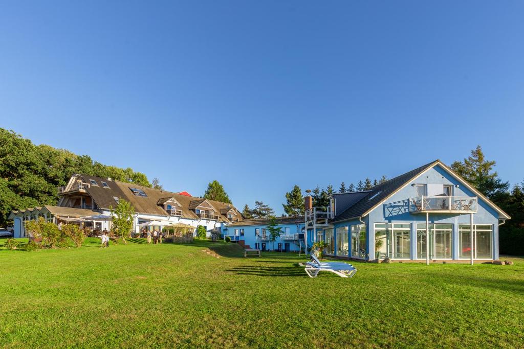 a large building with a lawn in front of it at Hotel Klaus Störtebeker in Ralswiek