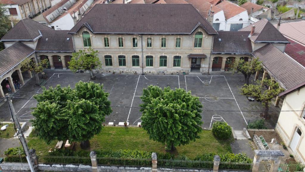 an aerial view of a large building with a basketball court at L'école buissonnière in Laroque-dʼOlmes