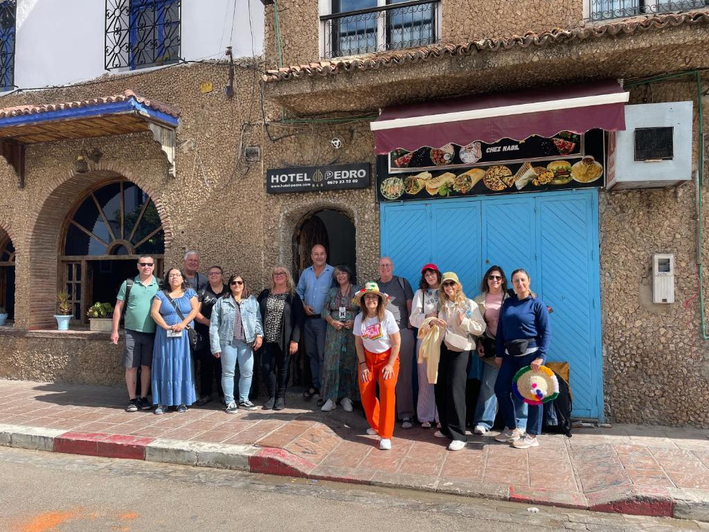 a group of people standing in front of a building at HOTEL PEDRO in Chefchaouen