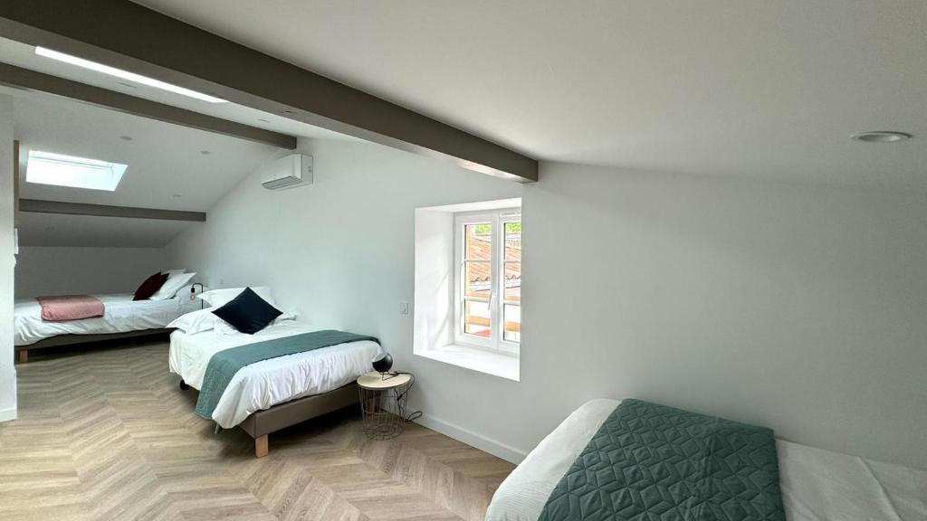 a bedroom with two beds and a window at Maison LAURENTZENIA in Saint-Jean-Pied-de-Port