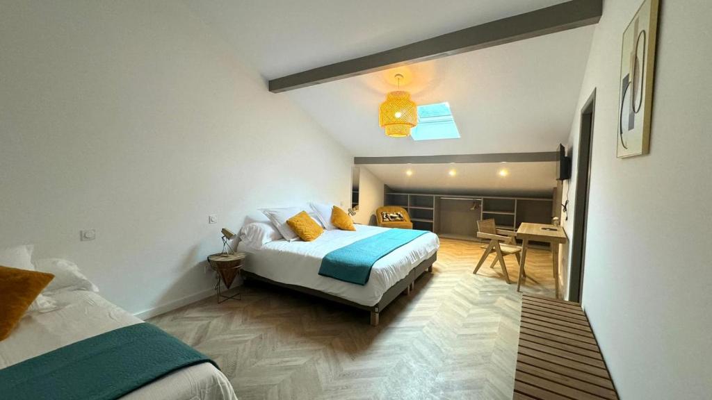 a bedroom with a bed and a desk in it at Maison LAURENTZENIA in Saint-Jean-Pied-de-Port