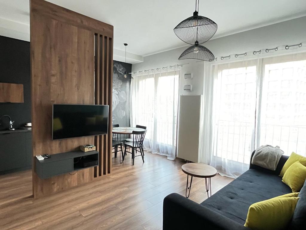 a living room with a couch and a tv at Apartament Serce Miasta in Wrocław