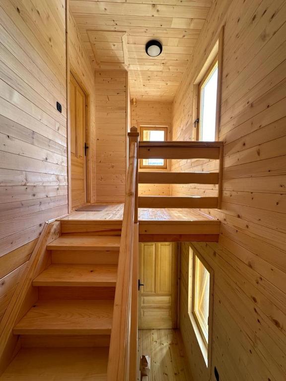 a wooden cabin with two stairs in it at Brvnara La Forêt in Žabljak