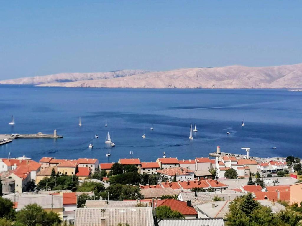a view of a city with boats in the water at Apartman TRALJE in Senj