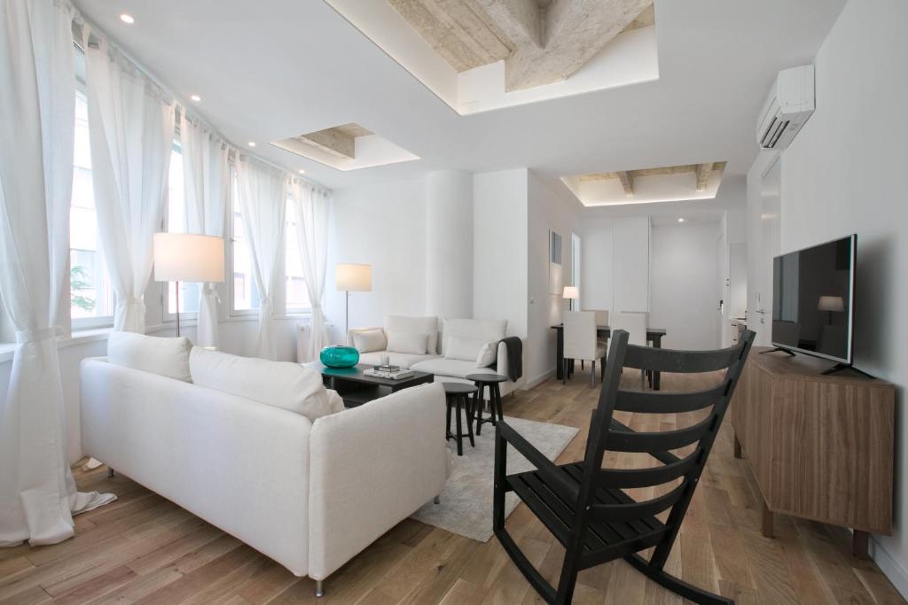 a living room with a white couch and a table at Apartments Angel Just 50 m from Zagreb Main Square in Zagreb