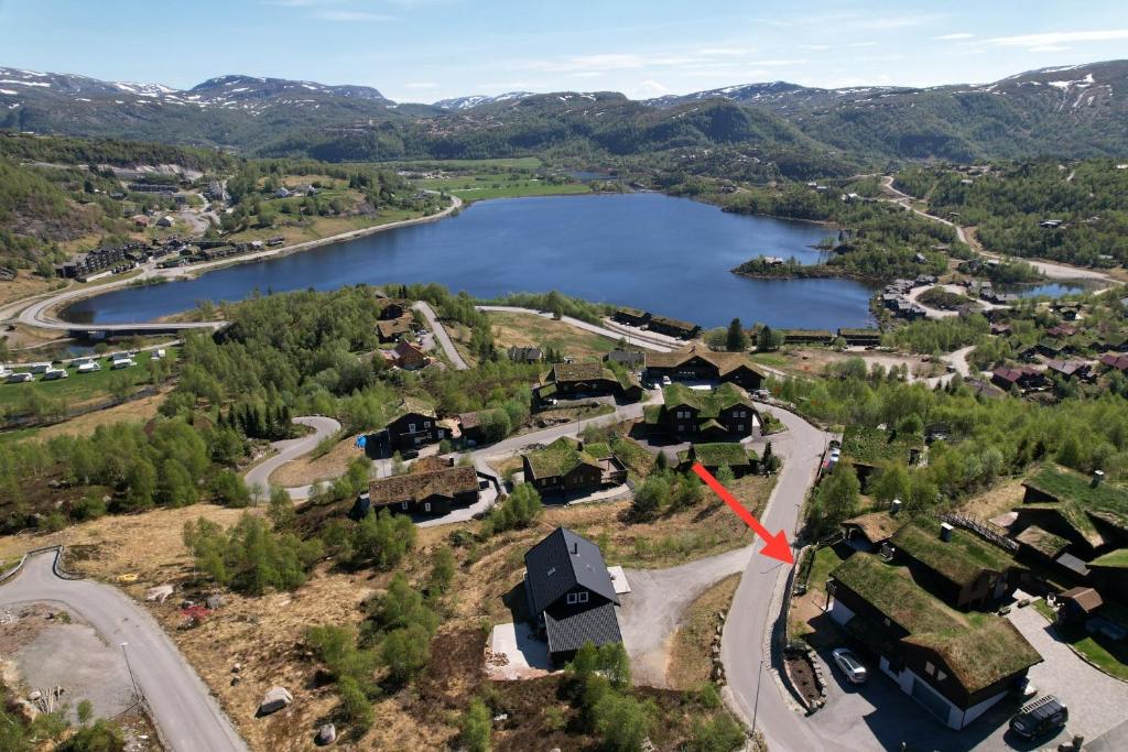 an aerial view of a house next to a lake at Holiday apartment close to Kjeragbolten in Tjørhom