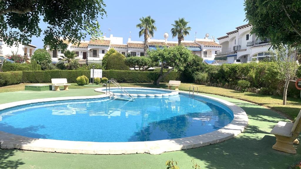 a large swimming pool in the middle of a yard at LagoVista45 in Torrevieja