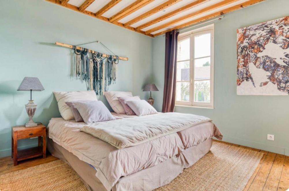 - une chambre avec un grand lit et une fenêtre dans l'établissement Maison de charme Beaumont, proche Deauville, à Beaumont-en-Auge