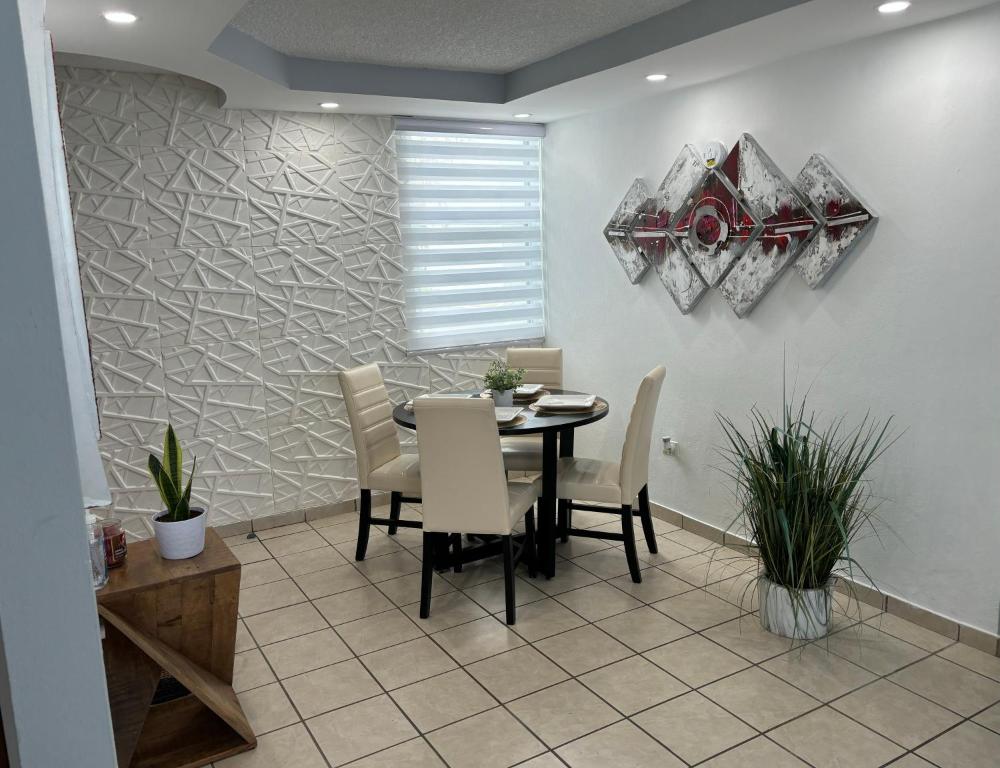 a dining room with a table and chairs at cozy private apartment near sju airport in Carolina