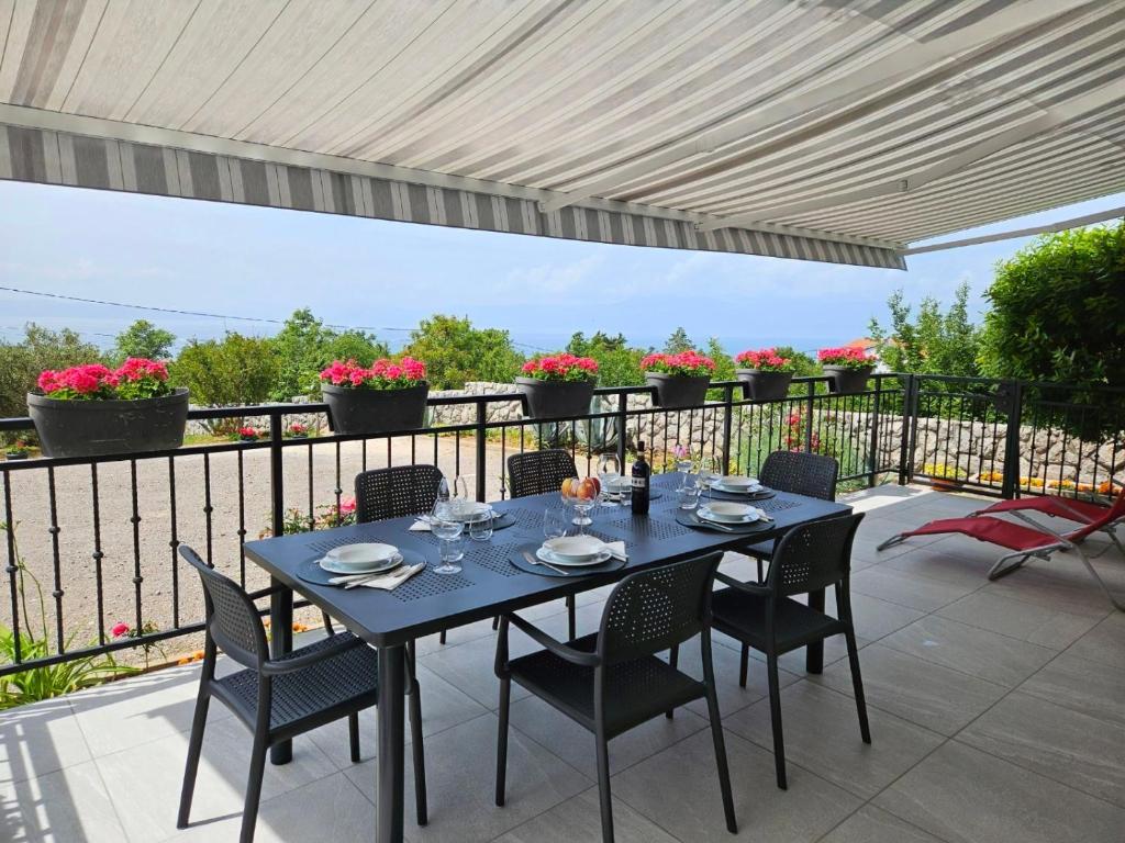 a blue table and chairs on a patio at Apartment Belvedere in Kraljevica