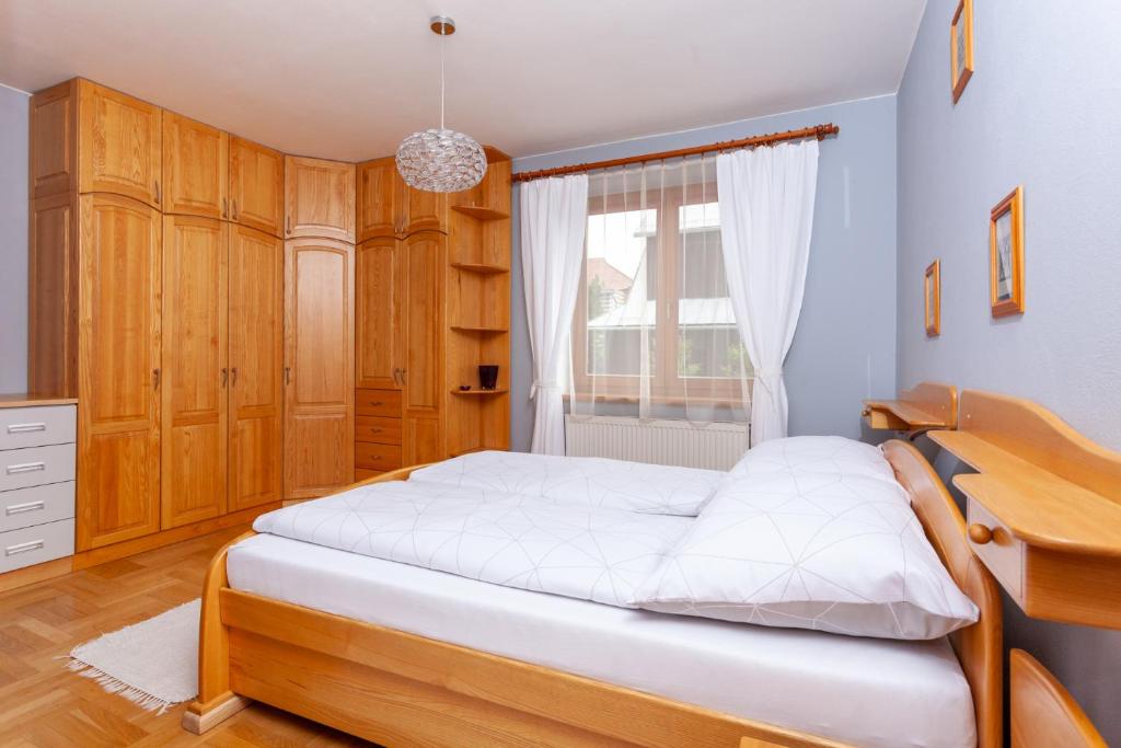 A bed or beds in a room at Penzión Javor