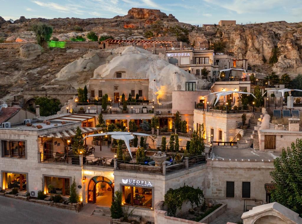an aerial view of a building with a mountain in the background at Utopia Cave Cappadocia in Urgup