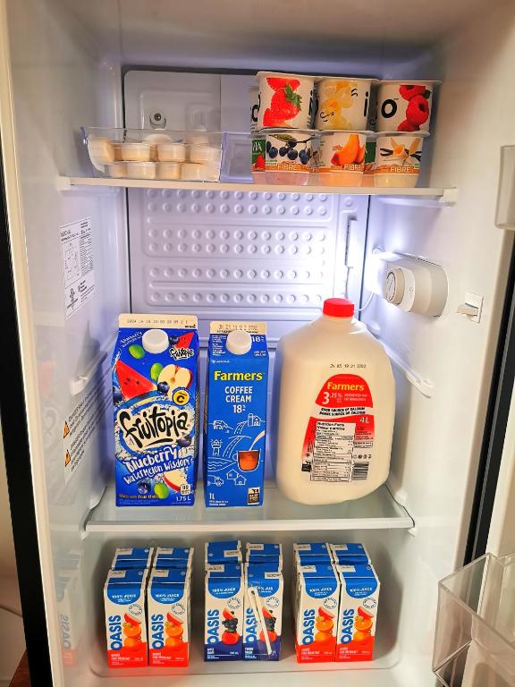 an open refrigerator with milk and other food items at 181 Oceanside Inn in Peggy's Cove
