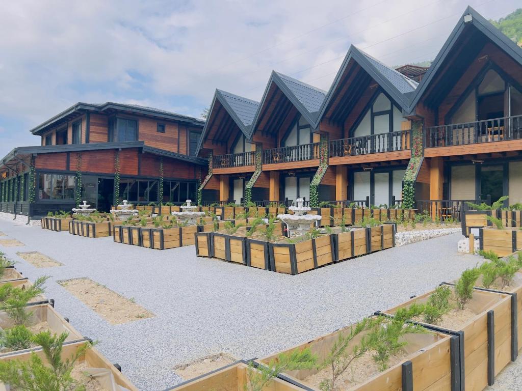 a house with a garden in front of it at Aquarium BUNGALOW UZUNGÖL in Uzungol