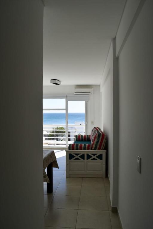 a hallway with a couch and a view of the ocean at Baleine in Puerto Madryn