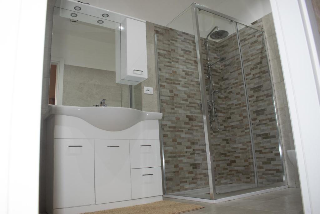 a bathroom with a white sink and a shower at Palazzo San Francesco in Scorrano