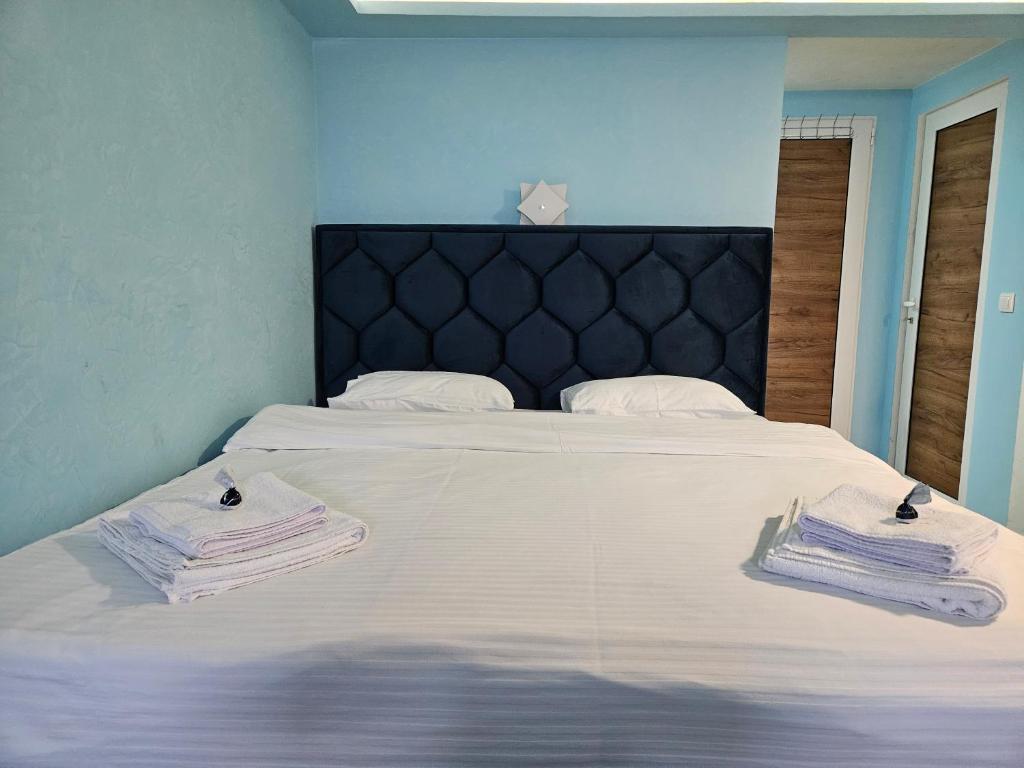 a bedroom with a bed with towels on it at Apartman Ivica in Pančevo