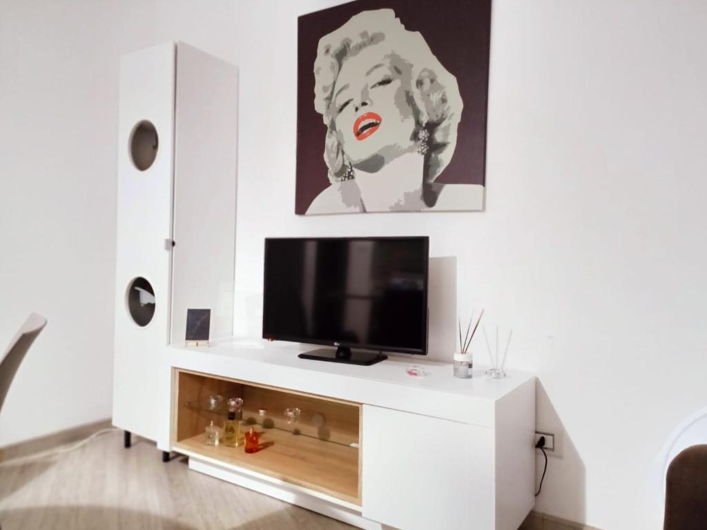 a living room with a white entertainment center with a tv at Casaagnese in Catania